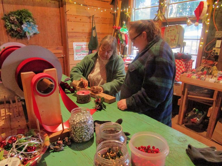 Robin Guthrie showing a visitor how to create bows